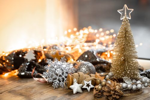 Christmas composition with a decorative tree, details of a festive decor on a blurred background with bokeh lights, copy space.
